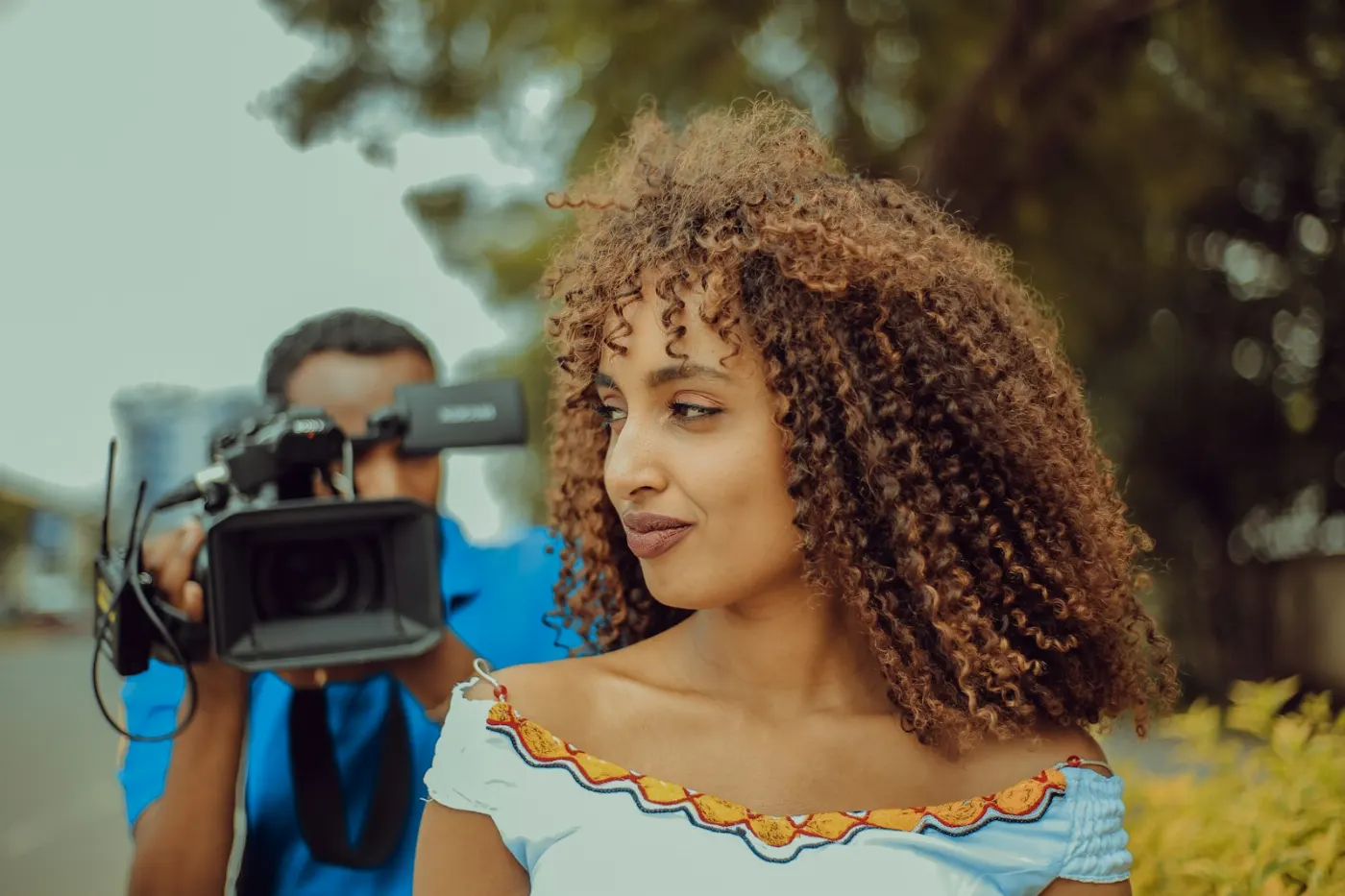 A creator being filmed for a sponsored video outdoors