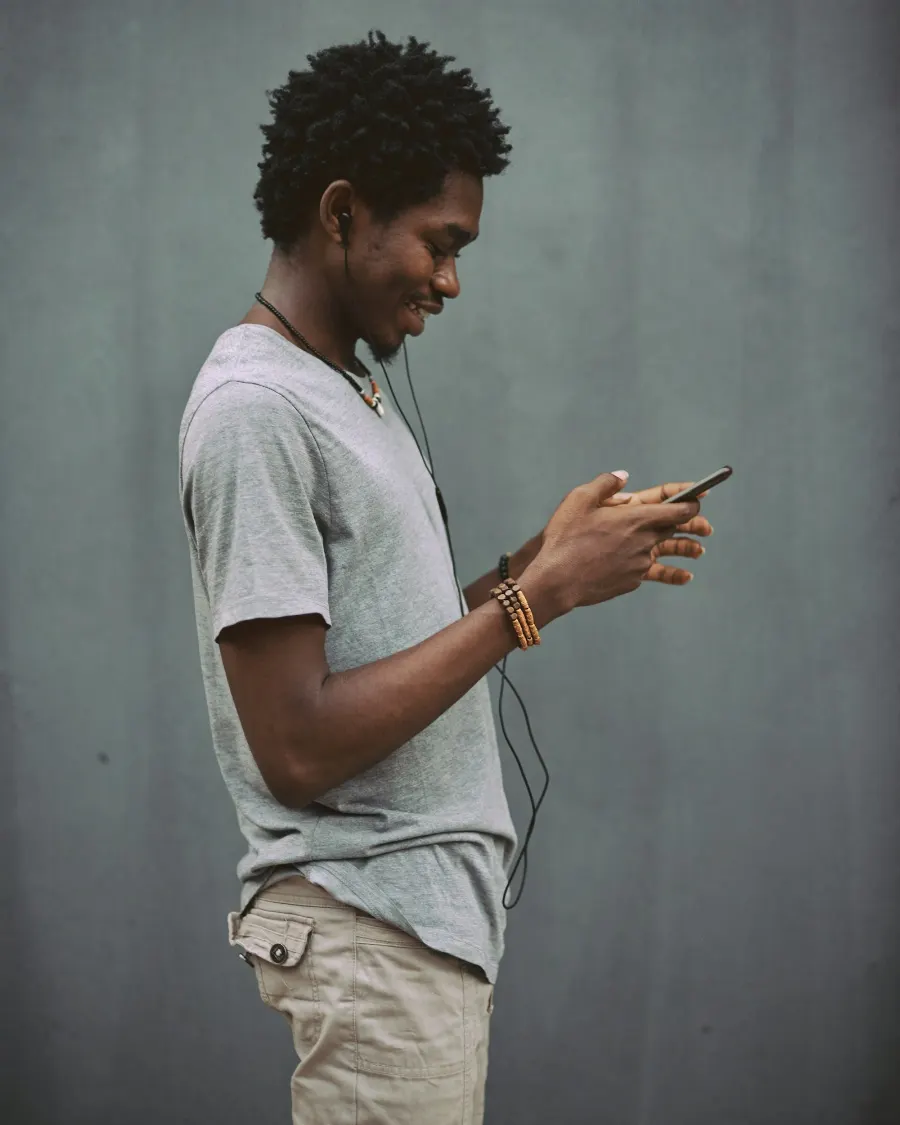 A young man checking a payment on his phone